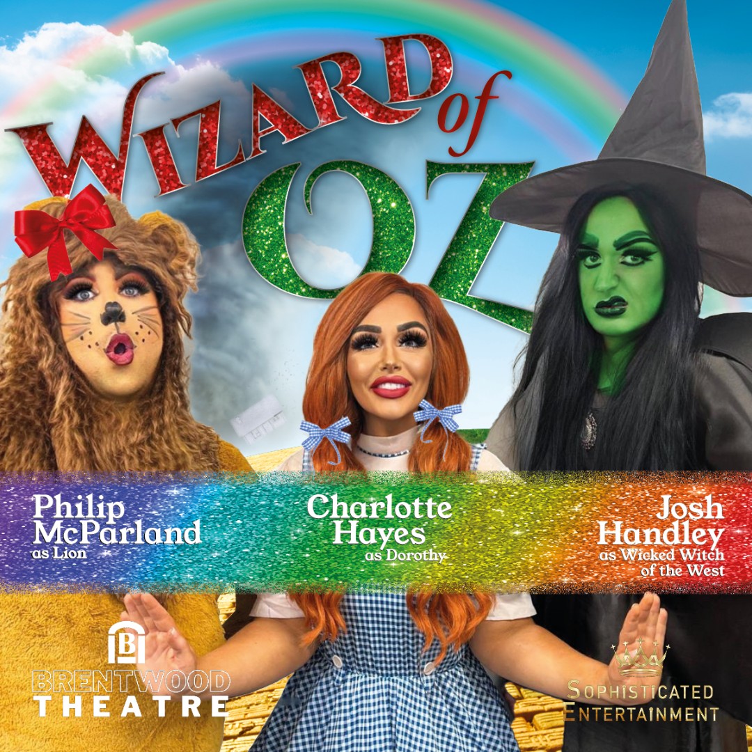 Image showing Phillip McParland, Charlotte Hayes and Josh Handley dressed as the Lion; Dorothy, with red hair tied in bunches and wearing a blue gingham dress; and the Wicked Witch in a witch's hat and green face from The Wizard of Oz.  Wording reads 'WIZARD OF OZ', with a rainbow and Brentwood Theatre and Sophisticated Entertainment logos