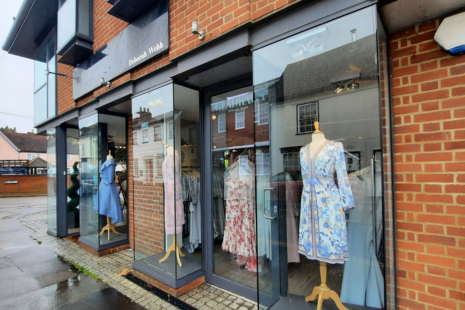 Image showing exterior of Gladrags in Ingatestone.  Three mannequins, wearing outfits, are visible, with rails of clothing behind.