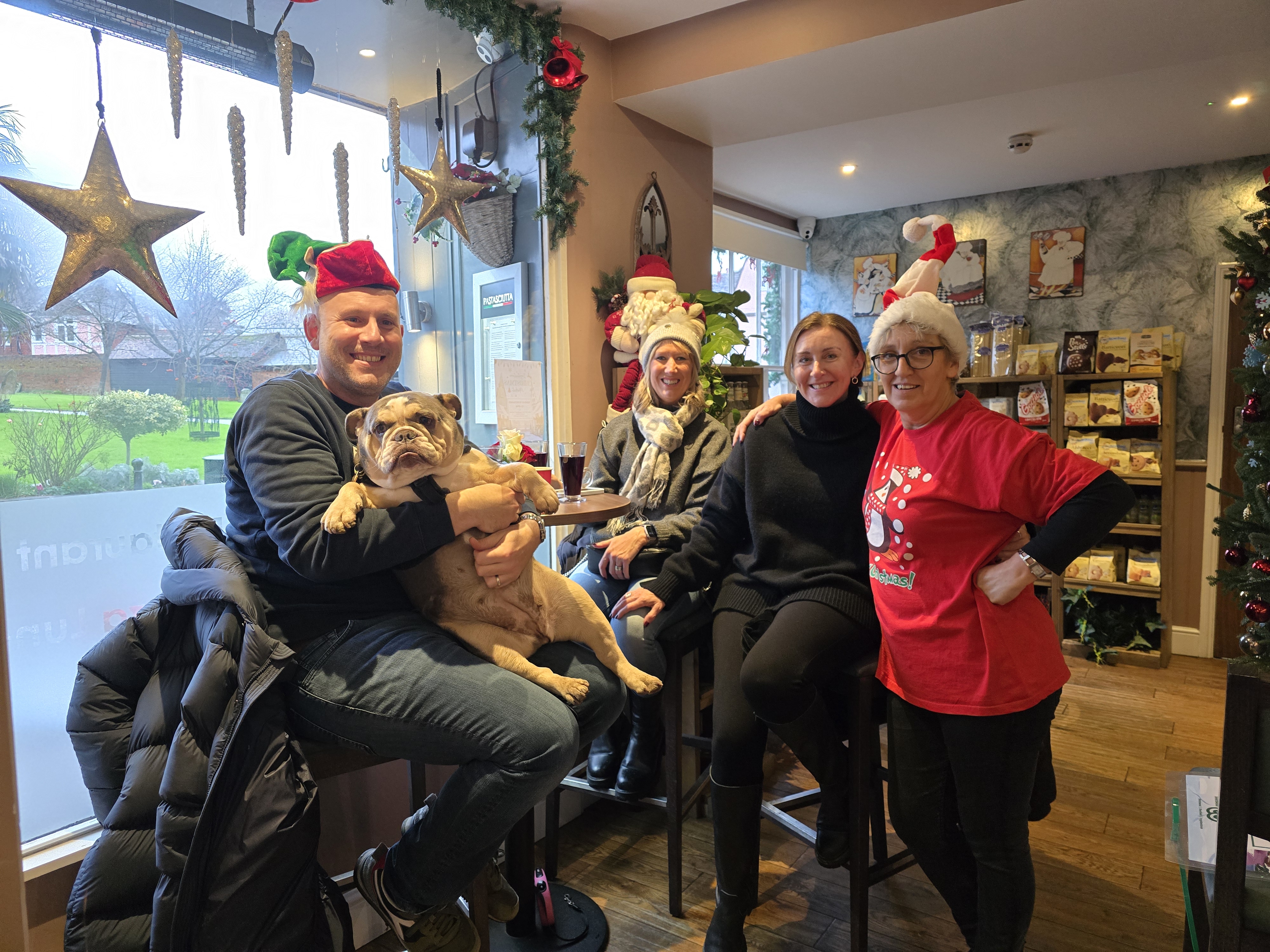 Image showing Laura from Pastasciutta in Ingatestone with customers and a dog wearing Christmas attire.