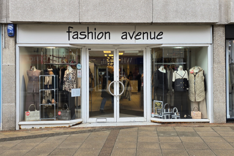 Image showing the exterior of Fashion Avenue in Brentwood.  The signage is white with black wording.  Mannequins are visible in the window.