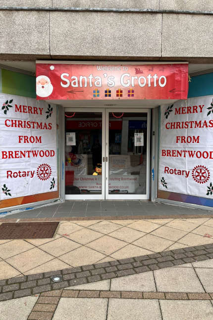 Image showing Santa's Grotto entrance, from the Rotary Club of Brentwood,with festive banners on either side.  Signage reads 'MERRY CHRISTMAS FOM BRENTWOOD ROTARY'.