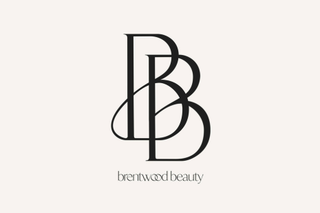 Brentwood Beauty logo - two large black Bs intertwined, with 'brentwood beauty' in black text underneath, with the two 'o's intertwined.  Pale pink background.