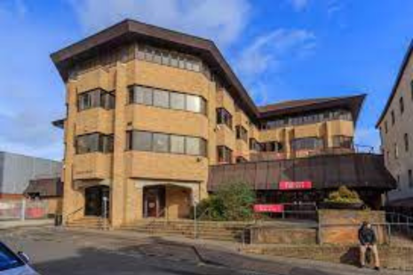 Image of the outside of Brentwood Library, a brick built building with a four storey building beside it.