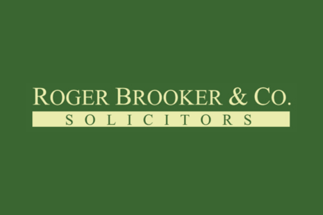 Logo for Roger Brooker & Co with yellow text on a green background and the word 'SOLICITORS' in green on a yellow background.