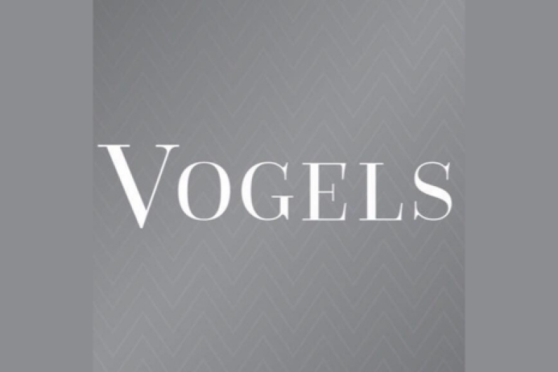 Vogels logo - white text on grey patterned background