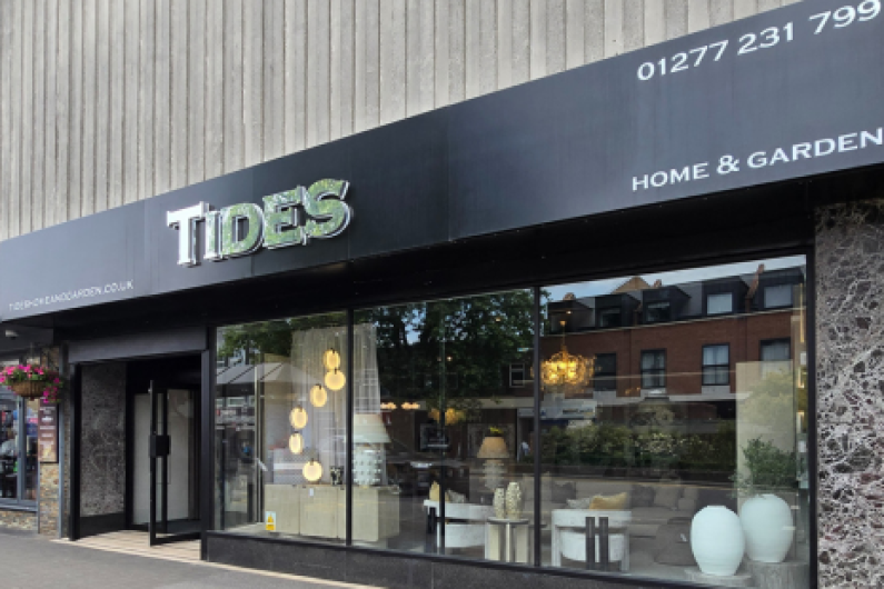 Image showing the front of Tides in Brentwood High Street, a black sign with silver letters.