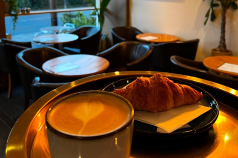 Image of a cup of coffee and a croissant, taken at Café 25a on Ongar Road, Brentwood.